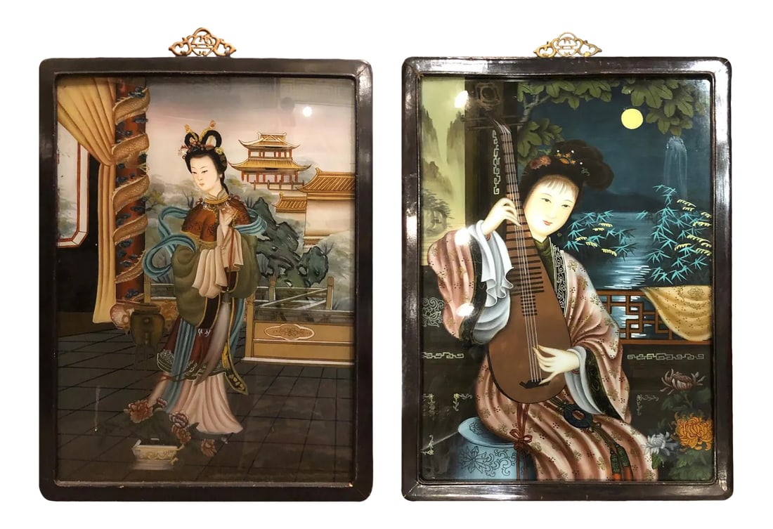 Early 20th Century Antique Chinese Reverse Portrait Paintings - A Pair: Two Chinese reverse paintings on glass depicting women. The first is standing in an interior with a view of a pagoda in the distance. The second posed seated playing stringed instrument. The images