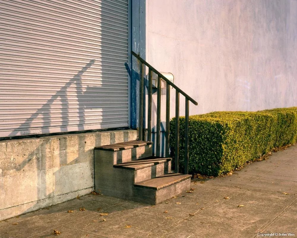 Contemporary Night Photograph "Steps and Hedge" by John Vias: Note from the artist, John Vias: "I liked this little scene with its steps and reflected shadow. It is a combination of the natural and constructed." This 11" x 14" archival color photograph is