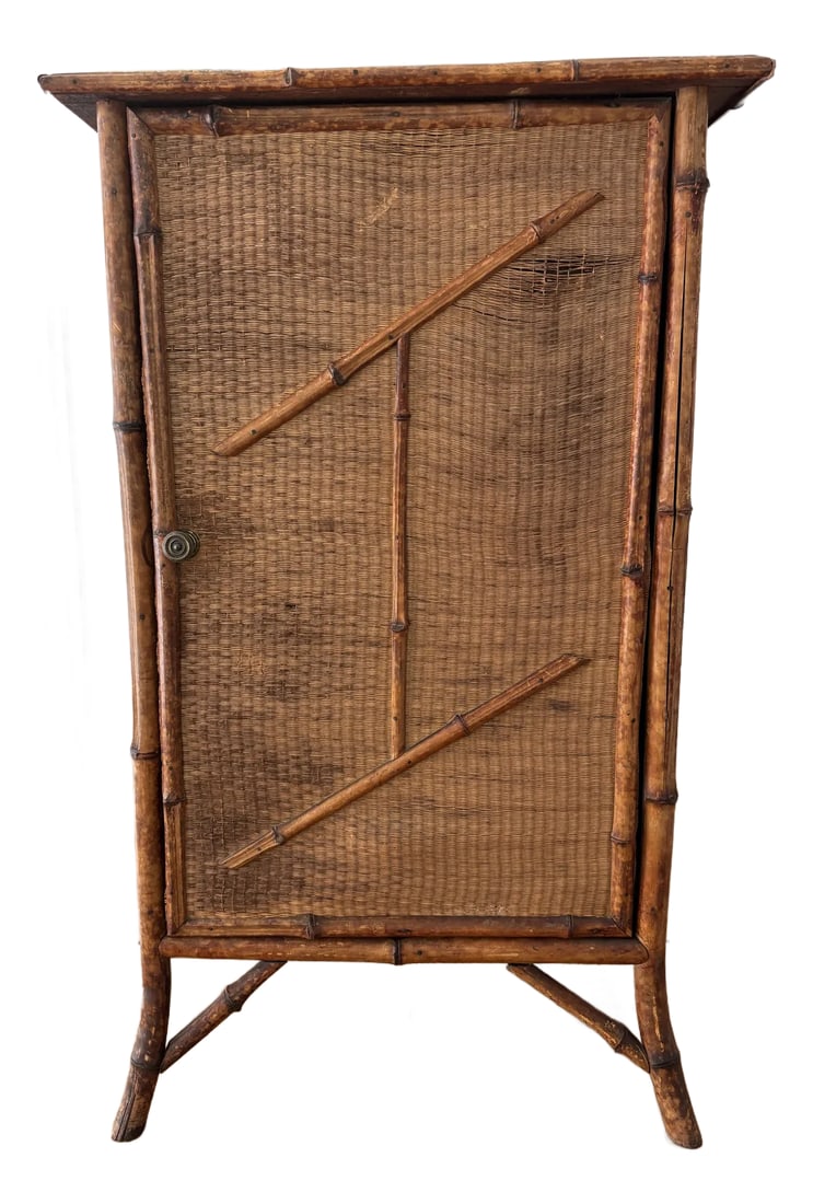 Early 20th Century Tortoiseshell Burnt Bamboo and Rattan Cabinet: Early 20th Century Tortoiseshell Burnt Bamboo and Rattan Cabinet. With original brass hardware and featuring a single door with tortoiseshell bamboo accents. Interior has 2 shelves. Raised on splayed