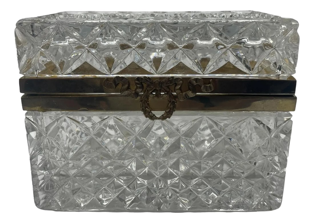 Antique Baccarat Style Crystal Box: An antique Baccarat style cut crystal box has brass trim framing the piece and an intricate wreath shaped closure. Perfect for storing jewelry or small treasures. 19th century, France. Condition: Alte