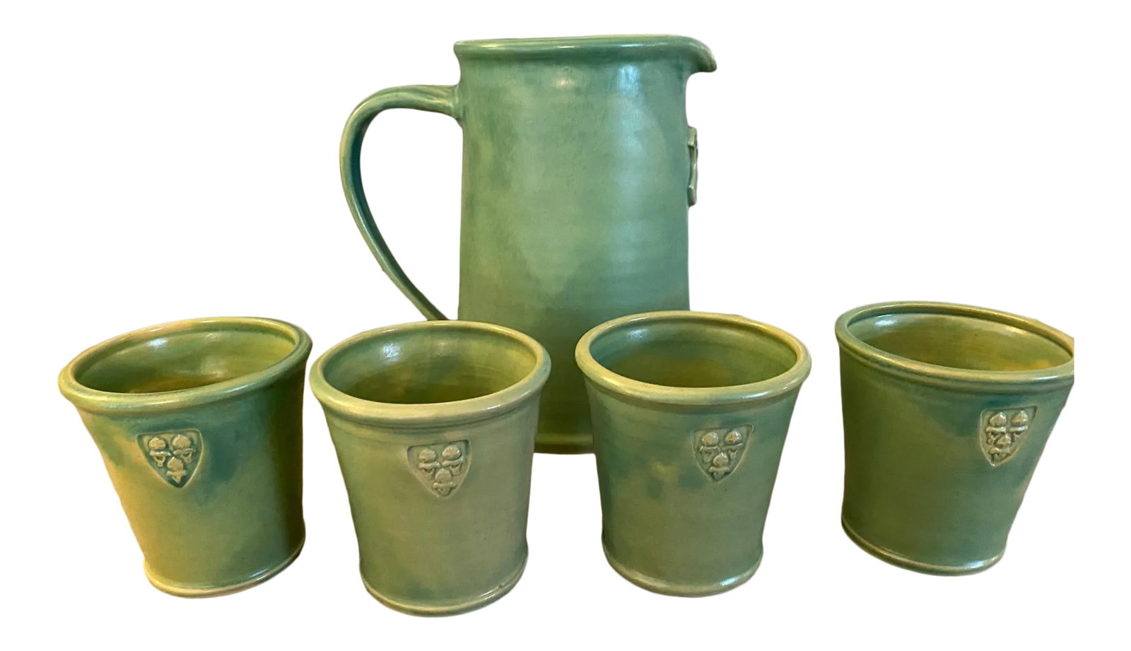 Arts and Crafts Ceramic Pitcher With Cups - 5 Piece Set: Strong and well made jug and 4 tumblers are in excellent condition. Does not look like they were ever used. I think they were made in Germany The decal that's applied in the same clay looks the be a