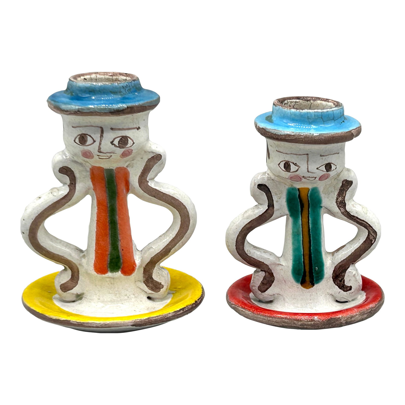 Pair of Vintage Giovanni DeSimone Ceramic Candlestick Holders, Italy: Vintage mid century candlesticks by Giovanni DeSimone, signed and marked "Italy" on the base with model numbers. Featuring stylized faces, sculptural handles, and bold glazes in red, yellow, teal, and