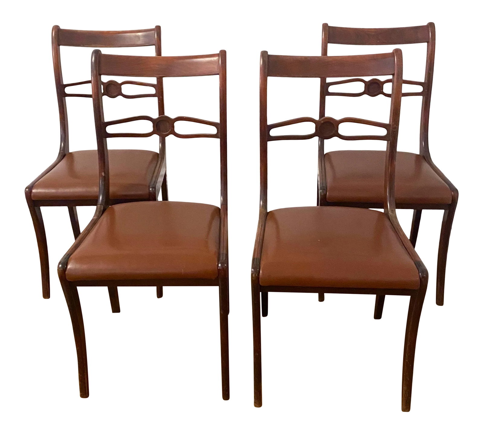 English Carved Mahogany Dining Chairs - Set of 4: Set of Four English Carved Mahogany Dining Chairs, 20th c. Arched canted curved back with a pierced horizontal stretcher, saber legs. H.- 33 1/2 in., W.- 18 in., D.- 21 in. Condition: Alterations: Res