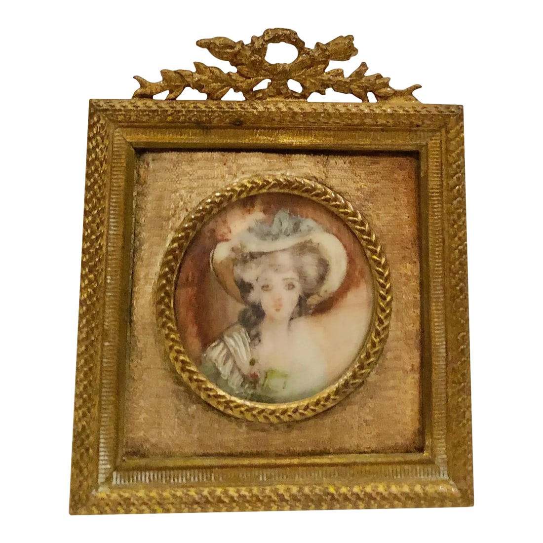 1910s Portrait of a Lady in a White Hat in Bronze Jewelry Frame: French picture is ivory of a beautiful girl in a white hat. It is signed bun can not make it out. Bronze jewelry frame with a beautiful little bow on the top. Circa 1910s. Condition: Alterations: Orig