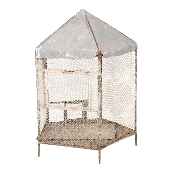 Antique French Birdcage: Antique pentagon birdcage from France. Features a wire mesh enclosure with a pointed metal rooftop.This birdcage is huge with amazing patina, age and character. A beautiful statement piece for any