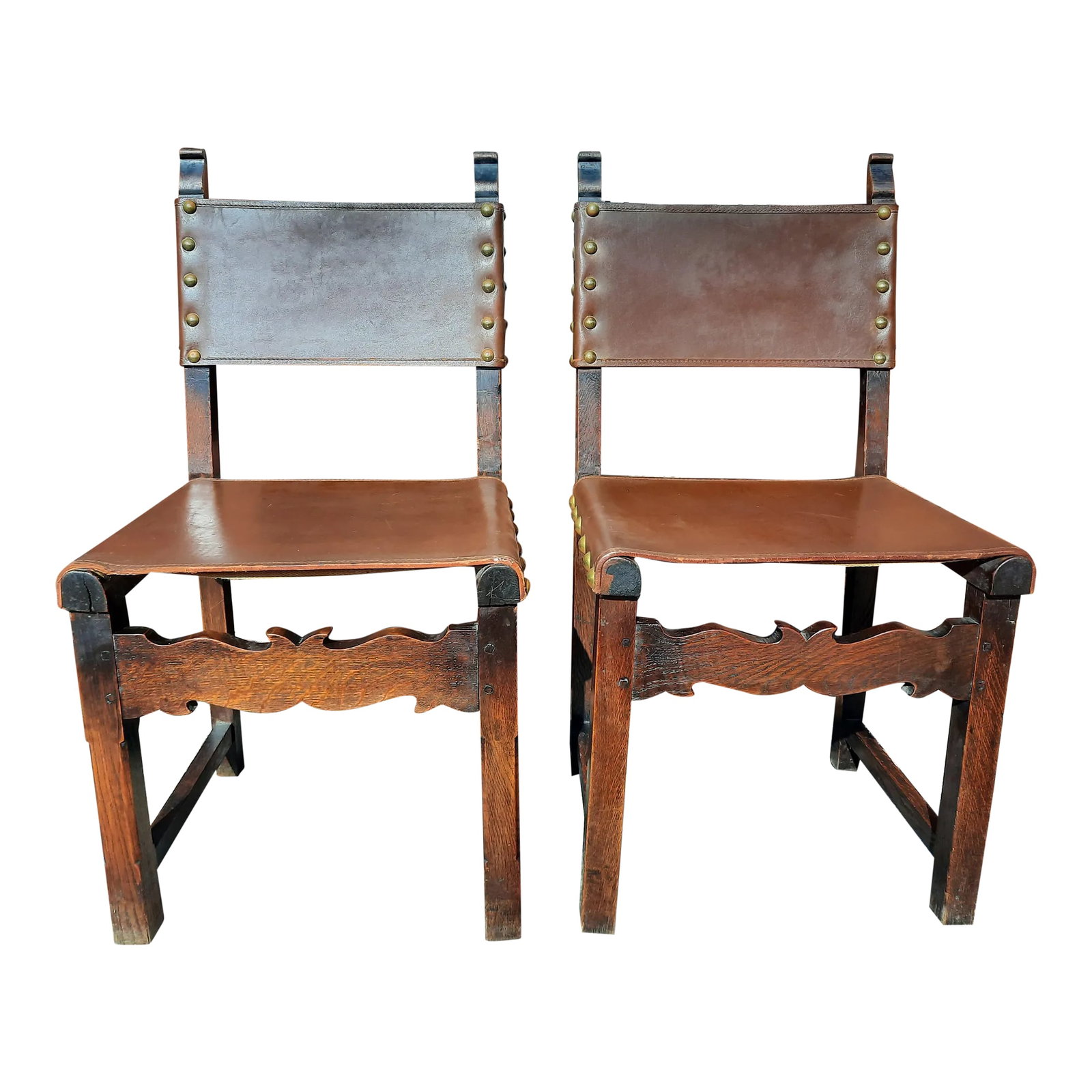 Antique French Leather Chairs - a Pair: Pair of Antique leather on French Oak Side Chairs. Original condition with some distressing on the leather and the solid oak frame. Antique brass large nail heads with a beautiful patina. Heavy chairs