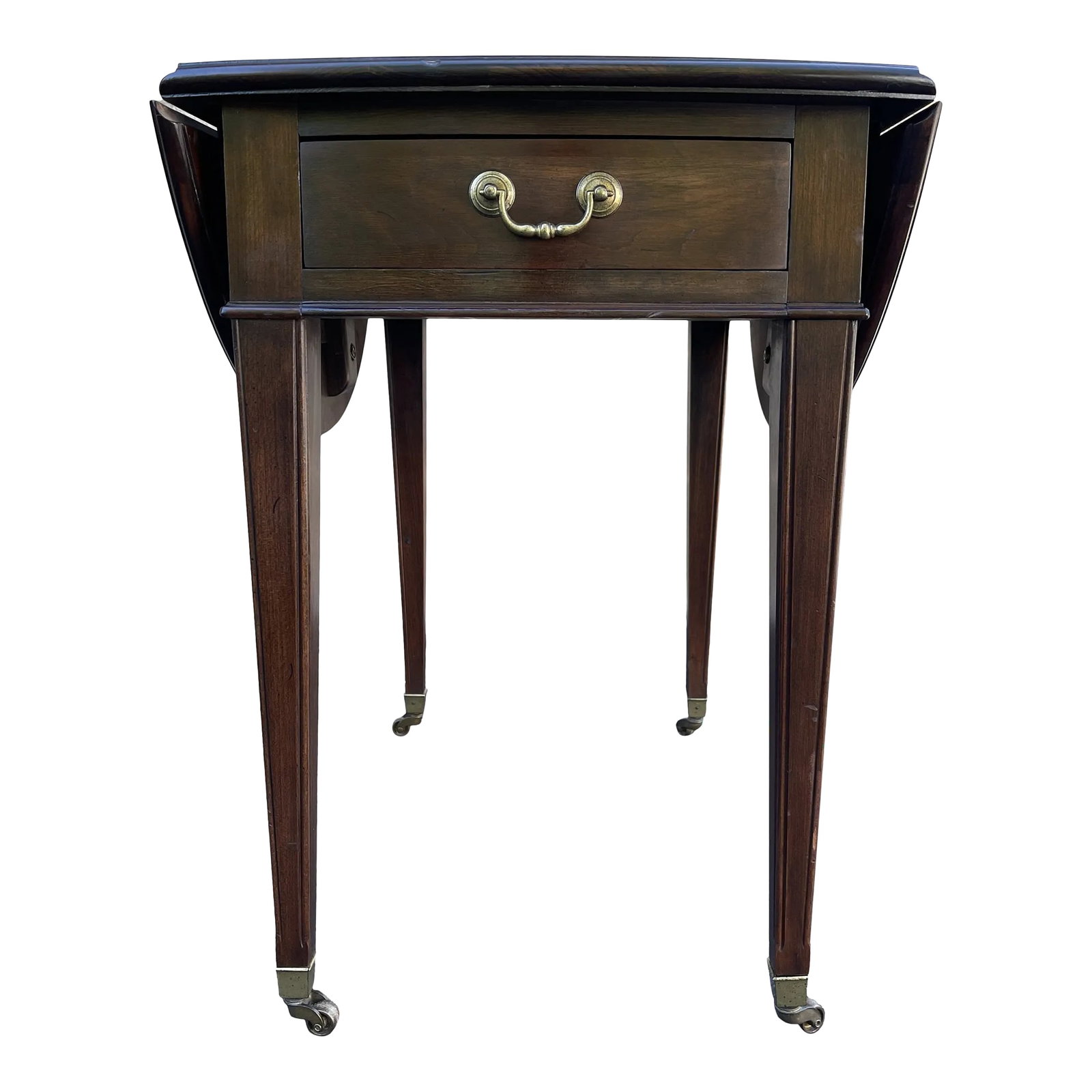 1970s Ethan Allen Georgian Court Traditional Cherry Drop Leaf Pembroke Side Table (11-8202): A late 20th century Ethan Allen Georgian Court collection Traditional cherry drop leaf Pembroke style side table having a rectangular / oval top over a single drawer with a polished brass bail pull