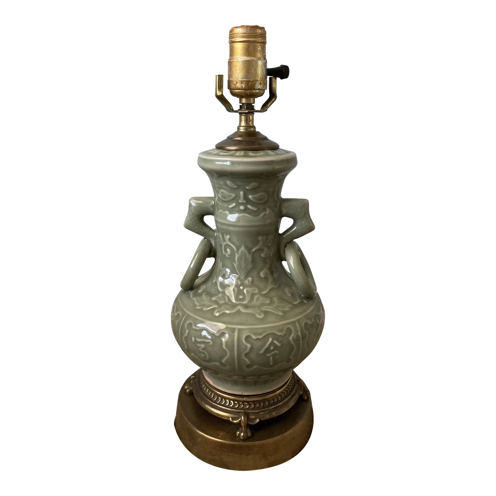 Mid 20th Century Deep Green Celadon and Brass Chinese Table Lamp: Excellent vintage condition. Fine detailing on the 4 feet that sit on the brass stand (not removable). The high relief double handles depict fish, while the main body exhibits in slight relief the bea