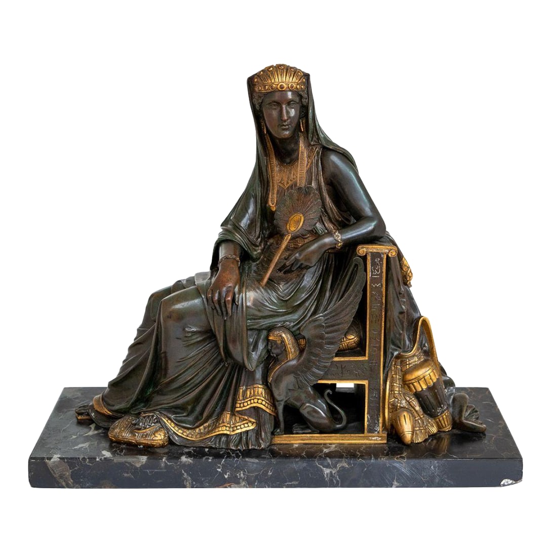 Leon Pilet "Cleopatra" Patinated Bronze, 19th C.: Leon Pilet (French, 1840-1916) "Cleopatra" Patinated and Gilt Bronze Sculpture, late 19th century, the seated queen holding a fan, signed to urn, on a Portoro marble plinth. 12.5" H x 14.5" W x 6" D. 