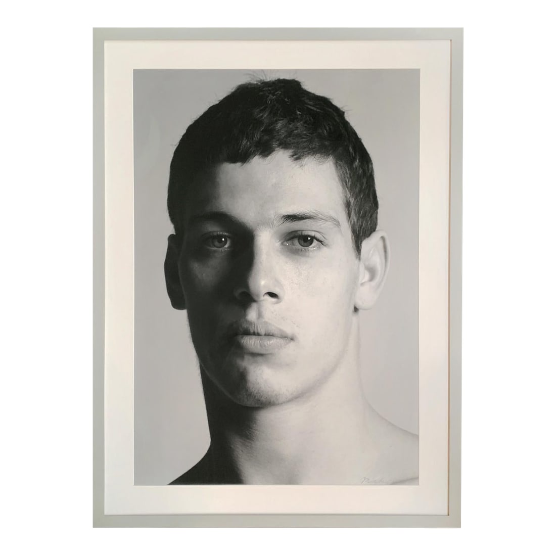1934 - Portrait by Christopher Makos: Titled "1934," this black-and-white pigment print is a striking portrait by the renowned photographer Christopher Makos. It is an intimate headshot of a young man. The portrait first appeared in