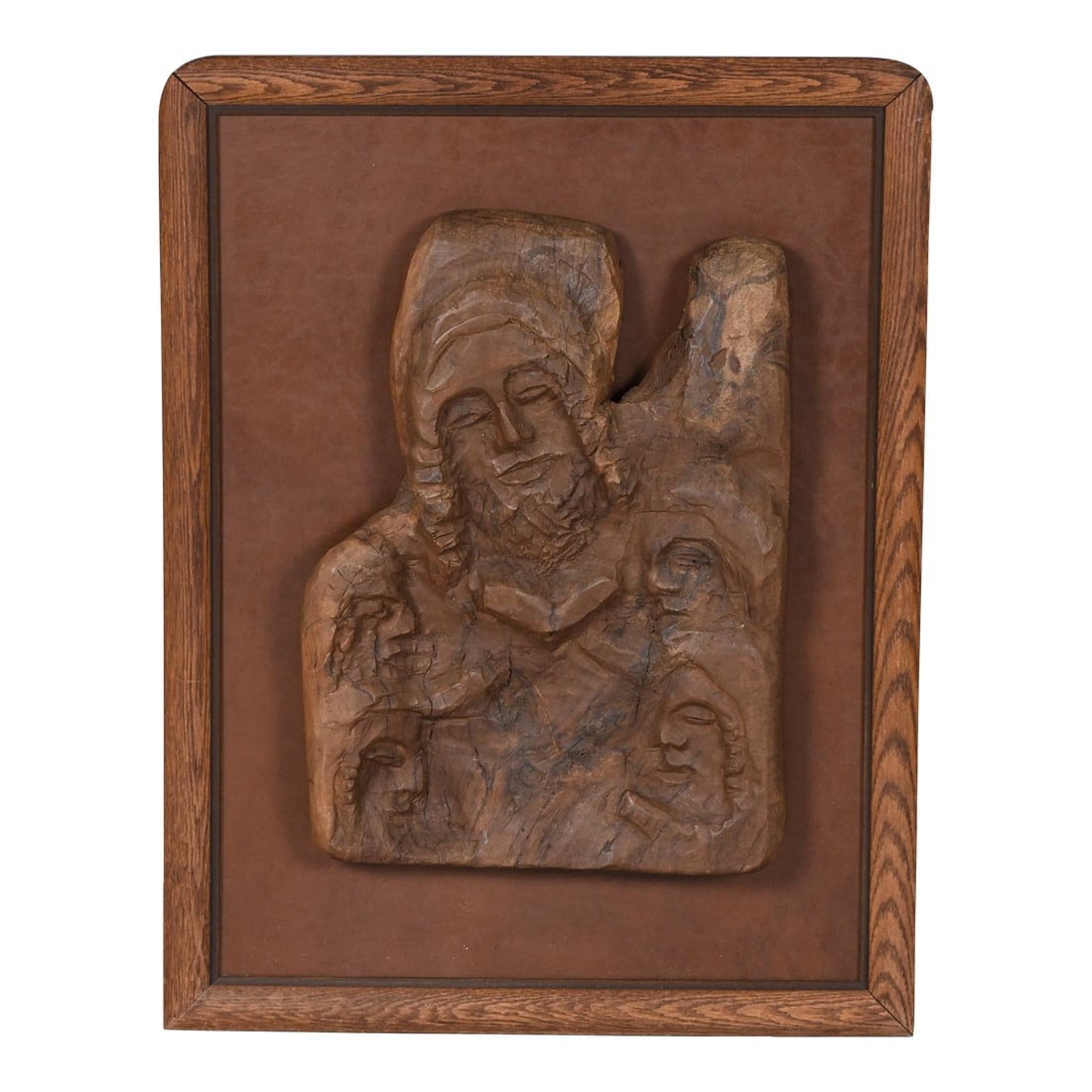 Hand-Carved Wood Relief Portrait With Leather Backdrop and Oak Frame: This striking piece of wall art showcases masterful craftsmanship and emotional depth through its three-dimensional wood relief carving. At the heart of the composition is a central portrait-serene
