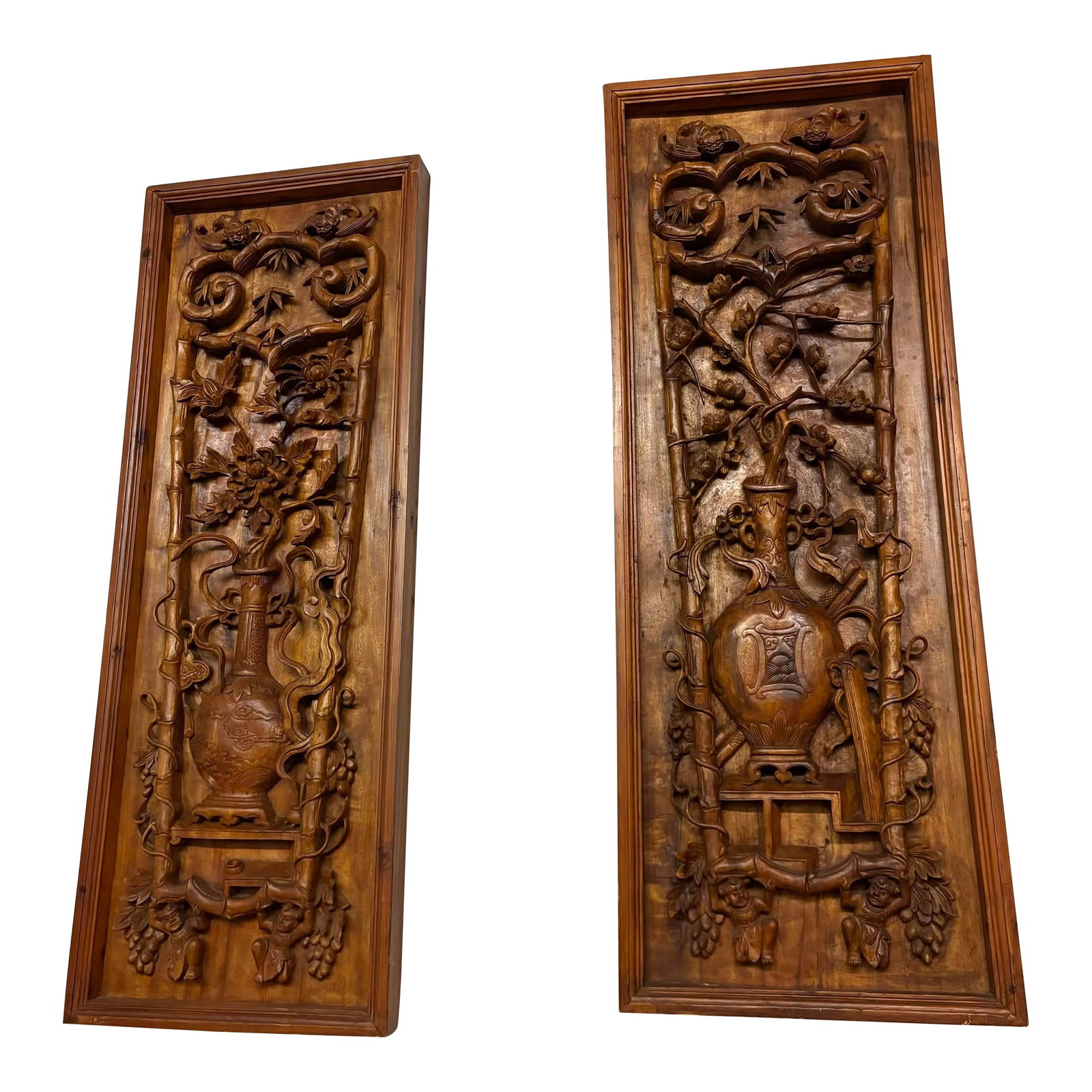 Pair of Large Antique Chinese Hand-Carved Wall Panels: A commanding pair of intricately hand-carved Chinese hardwood wall panels, each rendered in deep relief and framed by a bamboo-form border. These richly detailed compositions depict vases overflowing