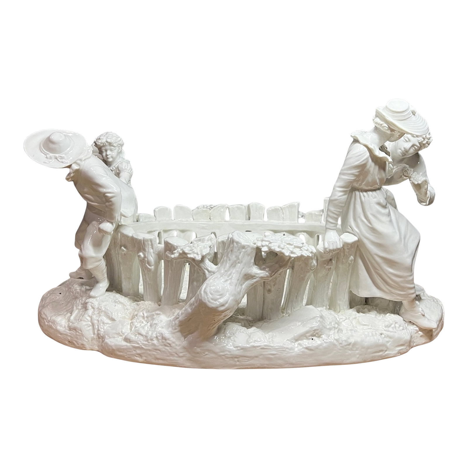 Antique White Porcelain Picket Fence Centerpiece With Courting Couple and Children Royal Worcester 1: This nearly 20-inch-wide Royal Worcester centerpiece, modeled by James Hadley around 1890, is a masterful orchestration of romantic and pastoral storytelling executed in luminous blanc de chine