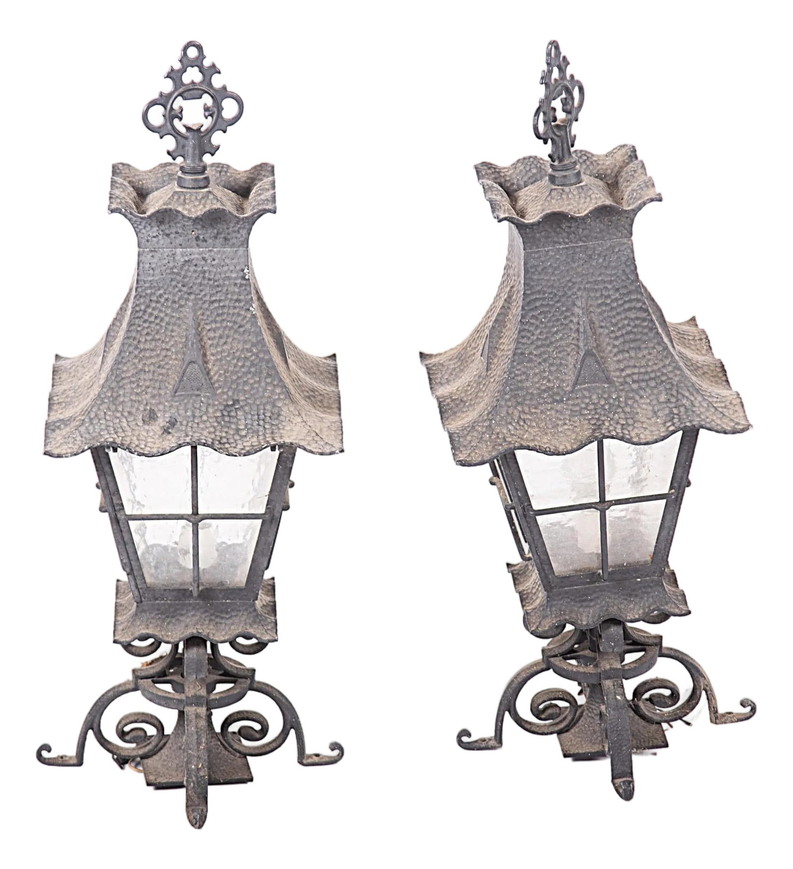 Pair of Spanish Revival Hammered Metal Lanterns - Vintage Late 20th Century: Spanish Revival lanterns, hammered conical form top with tapering glass shade resting on quadripartite legs. Each with a socket for a light bulb. Wired and ready for installation. 32" h x 12 x 12