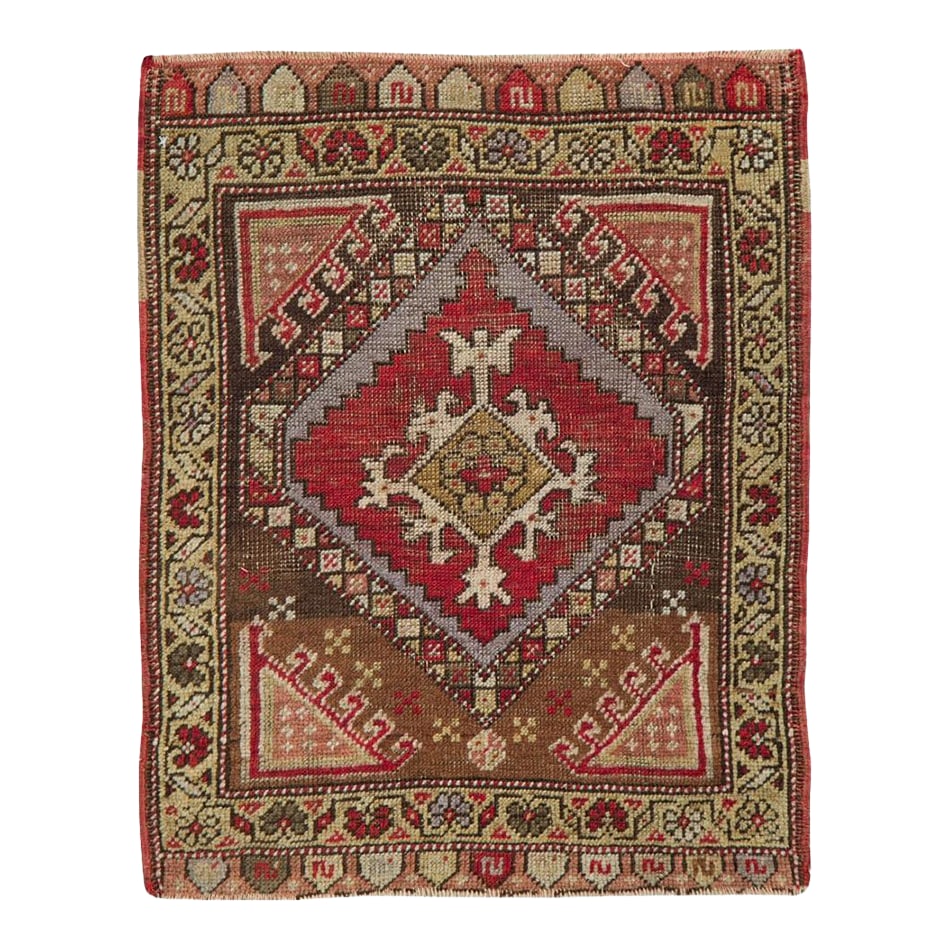 Galerie Shabab Collection Early 20th Century Turkish Anatolian Throw Rug: This Early 20th century Turkish Anatolian rug, measuring 1' 10" x 2' 2", captures the rustic charm and vibrant spirit of village weaving traditions. Featuring a striking diamond-shaped central