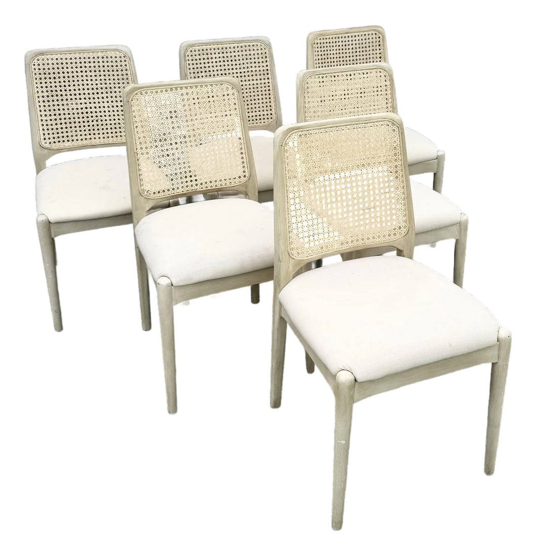 Safavieh Reinhardt Rattan Dining Chairs - Set of 6: A refined set of six Safavieh Reinhardt dining chairs featuring handwoven cane backs framed in a soft, limed wood finish. The gently curved silhouette is complemented by plush upholstered seats,