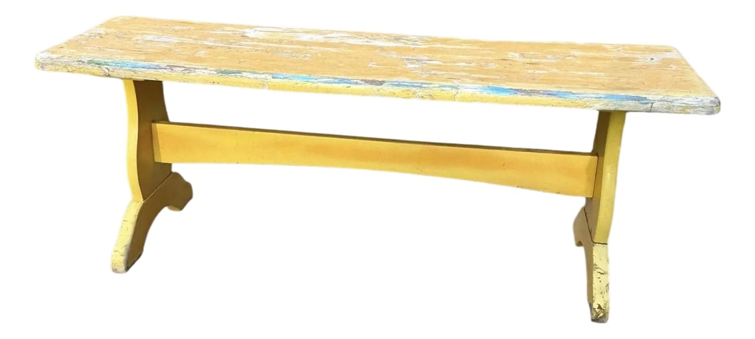 Vintage Trestle-Style Country Farmhouse Bench Storied Patina: Antique Primitive Painted Oak Farmhouse Bench Offering a heavy 4 foot long rustic wooden farmhouse bench with lots of character and patina. Layers of yellow and blue paint, aged naturally with a brigh