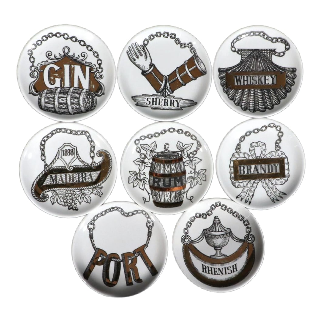 Piero Fornasetti Ceramic Wine & Liquor Coasters, Vini E Liquori Pattern: Mid-Century Mixology: A Complete Set of Piero Fornasetti 'Vini e Liquori' Porcelain Coasters Circa 1950s This charming and complete set of eight porcelain barware coasters designed by the iconic