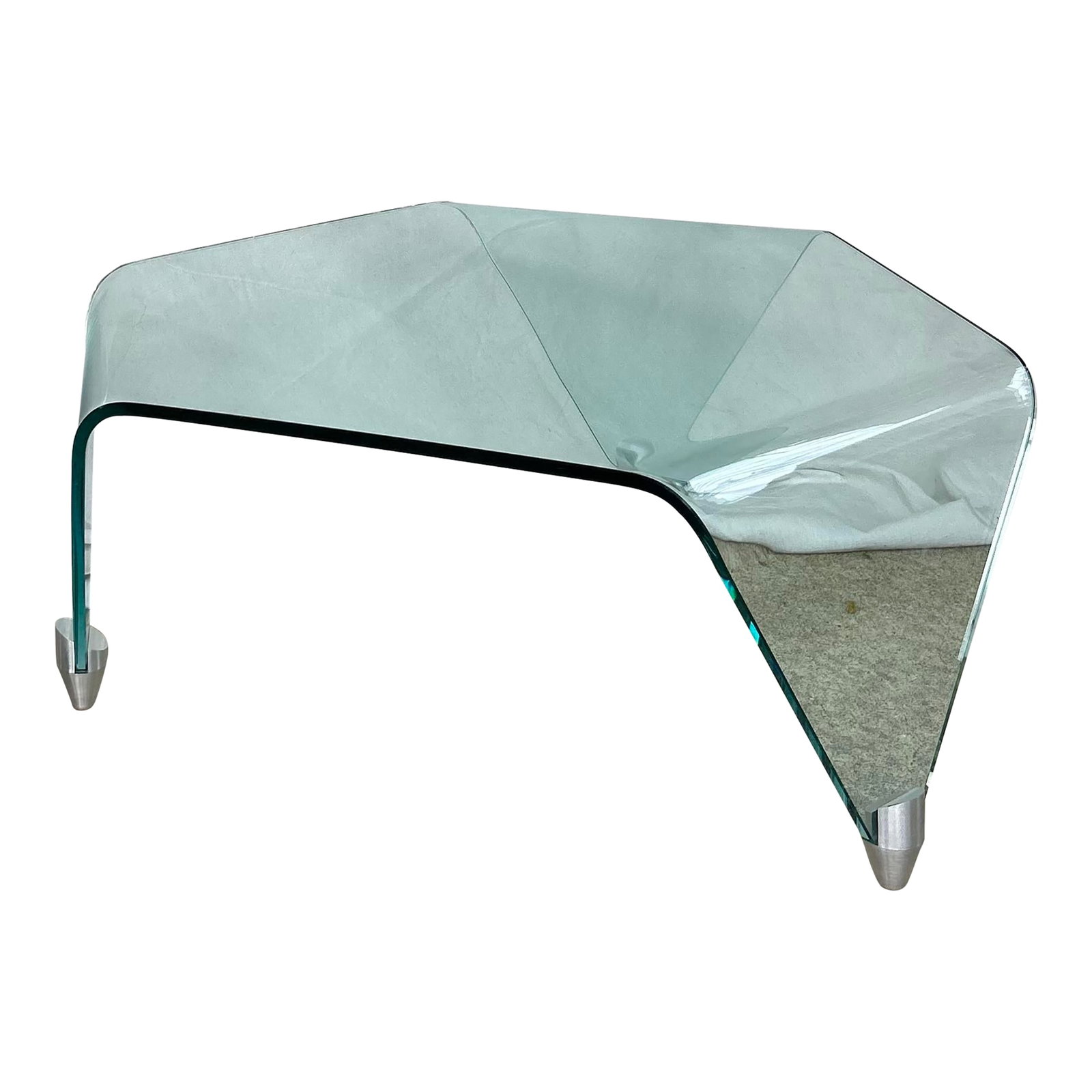 Sculptural Triangular Bent Glass Cocktail Table | Attributed to Fiam Italia | Italy, Circa: There are rooms that hold furniture, and then there are rooms that hold art. This is the latter. Architectural and ethereal, this vintage bent glass coffee table is Postmodern architectural balance.