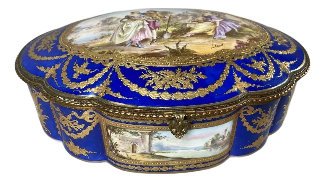 19thC Sevres Rococo Blue Porcelain Gallant Box - 1: A magnificent 19th-century French Sèvres porcelain box, richly decorated in deep cobalt blue with raised gilt ornamentation and a signed hand-painted gallant scene on the lid. This impressive