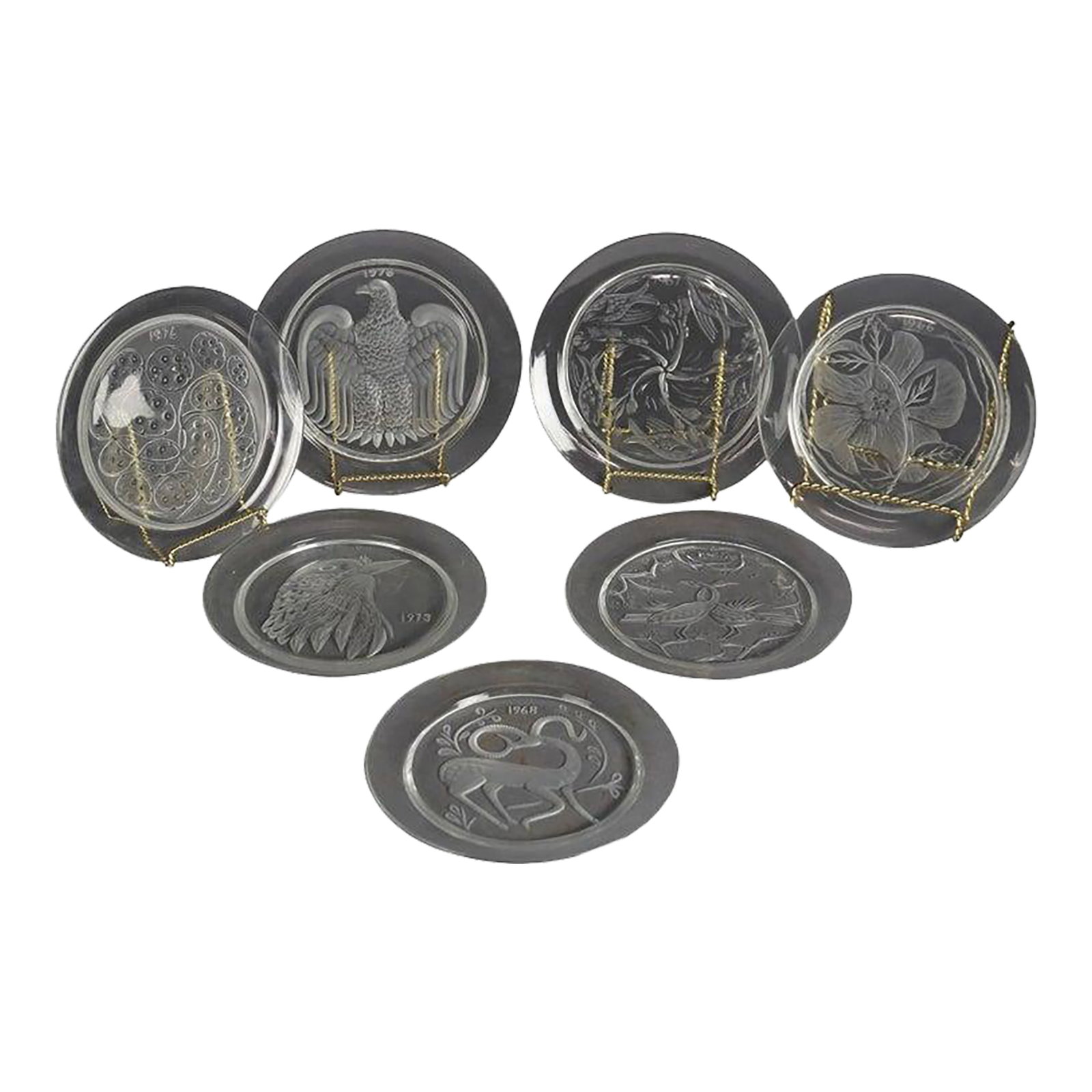 Early 20th Century Twelve-Piece French Lalique Commemorative Crystal Plate Set: Twelve-Piece French Lalique Commemorative Crystal Plate Set 20th C; Dates from 1965-1977. Measures- 8.5''H x 8.5''W x .5''D A striking set of twelve French Lalique commemorative crystal plates from
