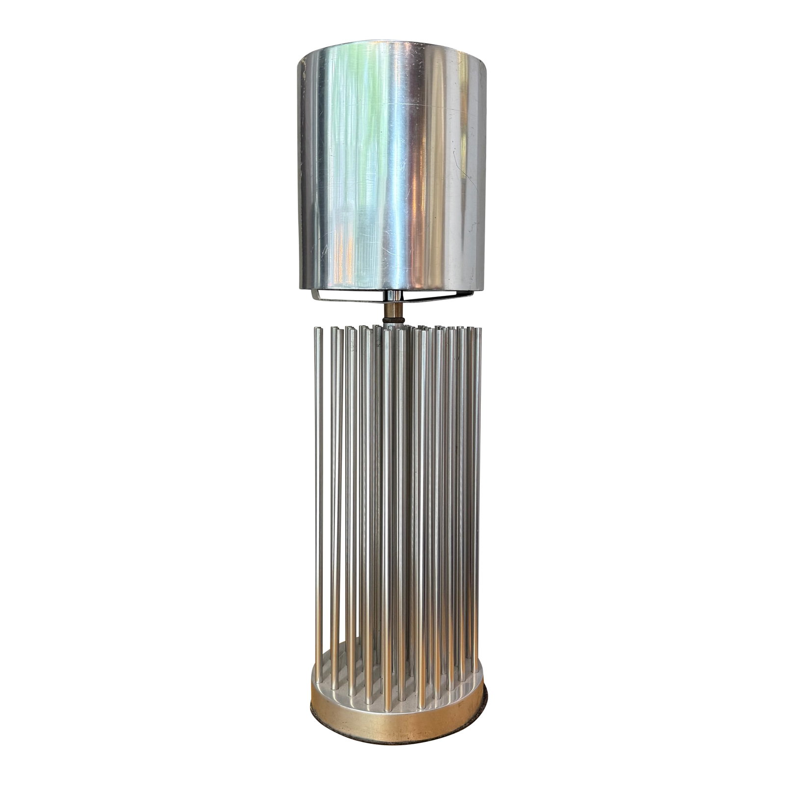 Mid 20th Century Small Modernist Aluminum Cylinder Reed Table Lamp: This small Modernist table lamp circa the 1980s features an interesting, architectural aluminum cylinder base constructed from reed like poles topped with a sleek polished aluminum cylinder shade. Thi
