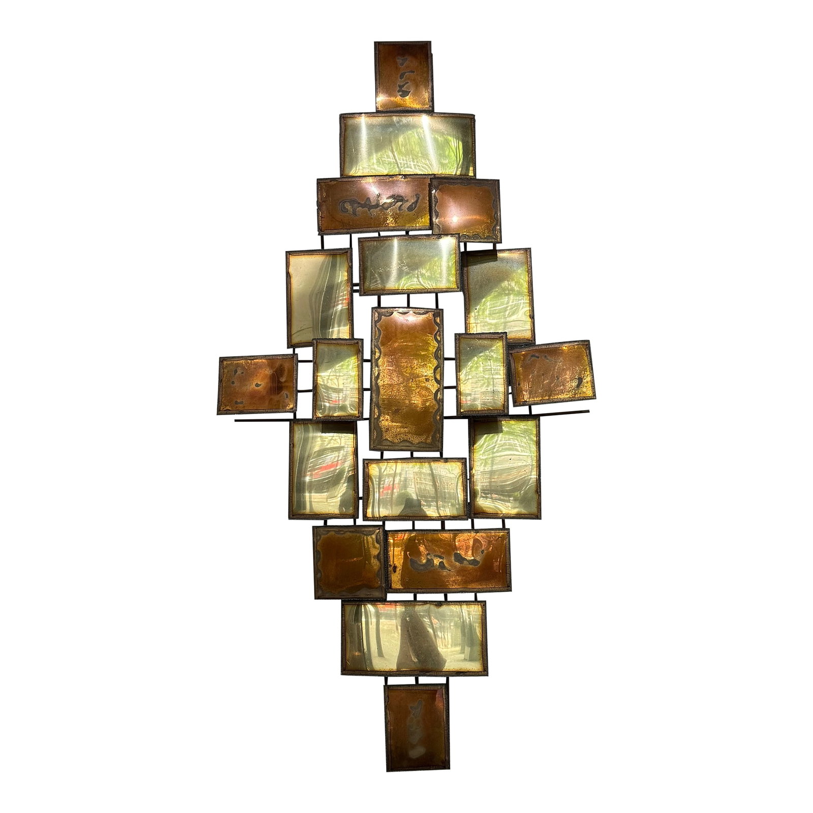 1970s Brutalist Multi-Panel Metal Wall Sculpture in the Style of Mario Jason: Add some architectural drama to your walls with this stunning 1970s Brutalist wall sculpture in the style of Mario Jason. Handcrafted from a patchwork of geometric brass and copper toned panels, this 