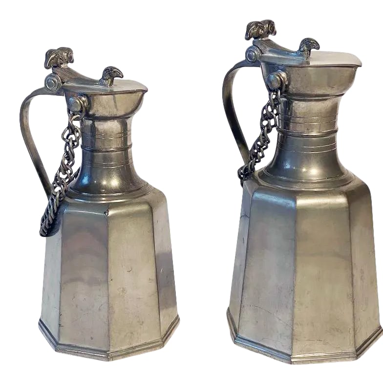 Vintage Swiss JPJ Geneve Pewter Pitchers - a Pair: Two rare exceptional shaped collectible JPJ Geneve Fine Pewter Lidded Pitchers with Ram Heads. Taller one is 6.25 x 6.25 x 12.75 H - Shorter one is 5.75 x 5.75 x 11.75. Condition: Alterations: