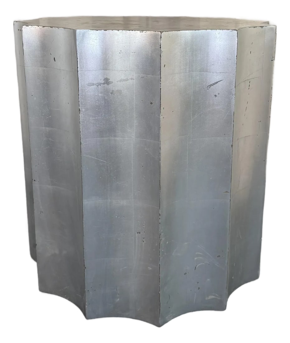 Sirmos Silver Leaf Doric Drum Side Accent Table: This sculptural, fluted Doric column drum table by The Sirmos Company, draws from classical architecture, executed with a distinct Hollywood Regency flair. It is finished with hand-applied silver