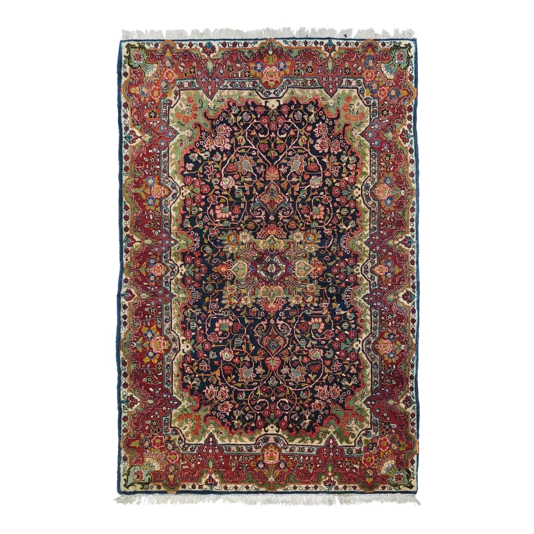 Vintage Sarouk (One of Pair) Rug 4'4'' X 6'10'': This vintage, west Persian rustic scatter features a notched and flaming rectangular navy sub-field with a four palmette octogrammoidal medallion centred on a wine red rosette. Staccato ecru vinery.