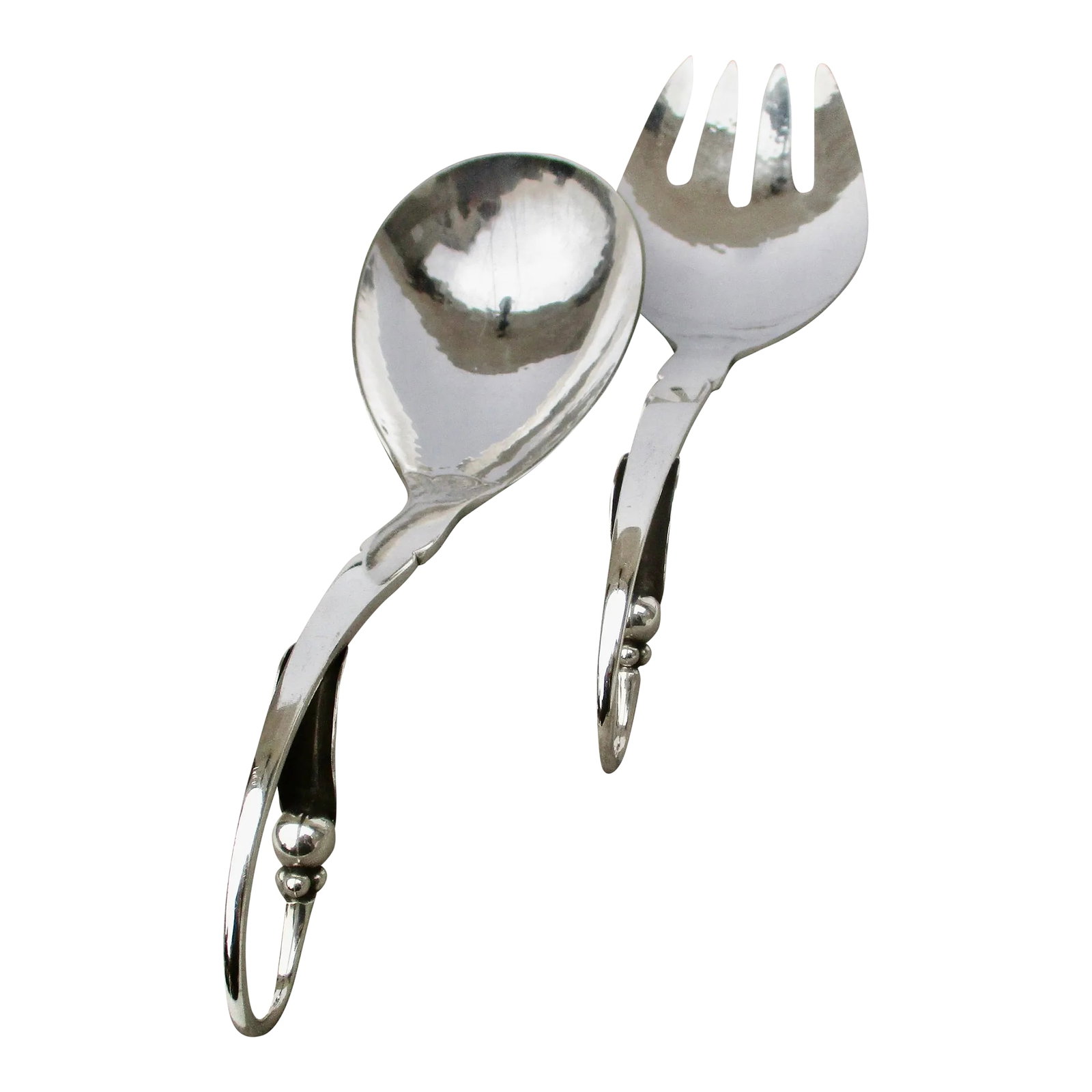 Georg Jensen Sterling Silver Serving Set -A Set of 2: Georg Jensen set of sterling silver serving fork and spoon. Classic deco leaf and bud in a curling handle design. The size is 9.5" long for the fork and 9" for the spoon. Hallmarked to the back of