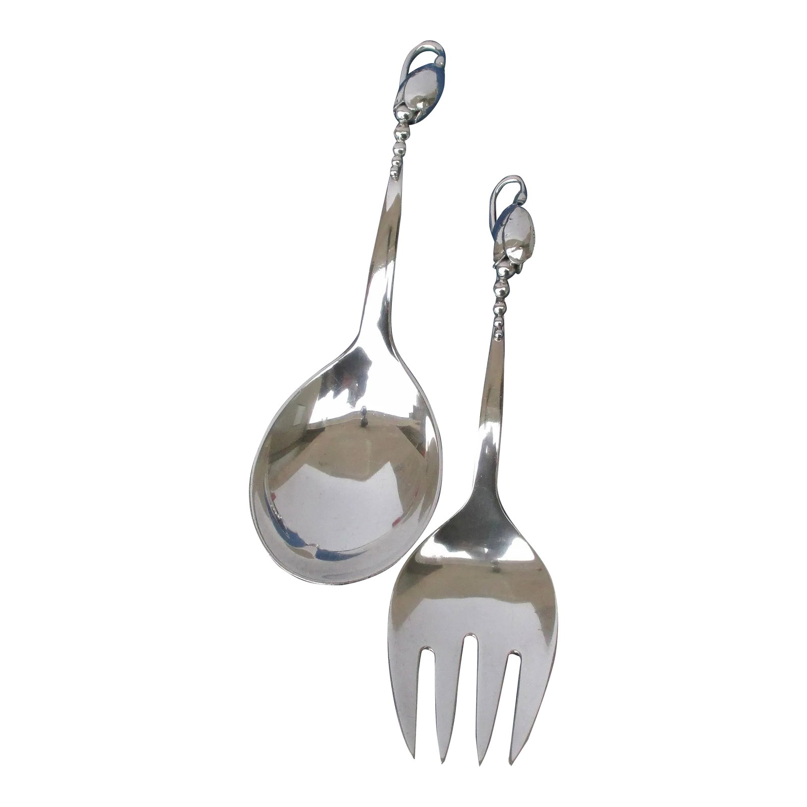 Georg Jensen "Blossom" Serving Set Circa 1930s. - Set of 2: Georg Jensen pattern "Blossom" by Christian Heise. Organic pattern of lily of the valley motif. Mid-century medium-sized set. The size is 8.5" long and 8' long. Beautiful art deco design. The conditio