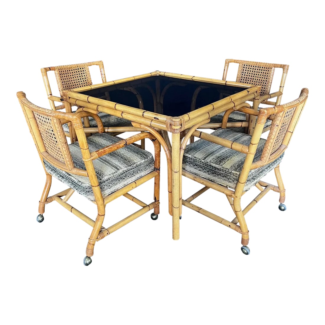 Ficks Reed Style 1950s Mid Century Rattan Dining Table and Four Caned Chairs -Set of 5: Authentic and rare mid century indoor, outdoor or patio rattan dining set consisting of a four-strand arch legged steam bent dining table with X stretcher and four marvelous matching steam bent arm or