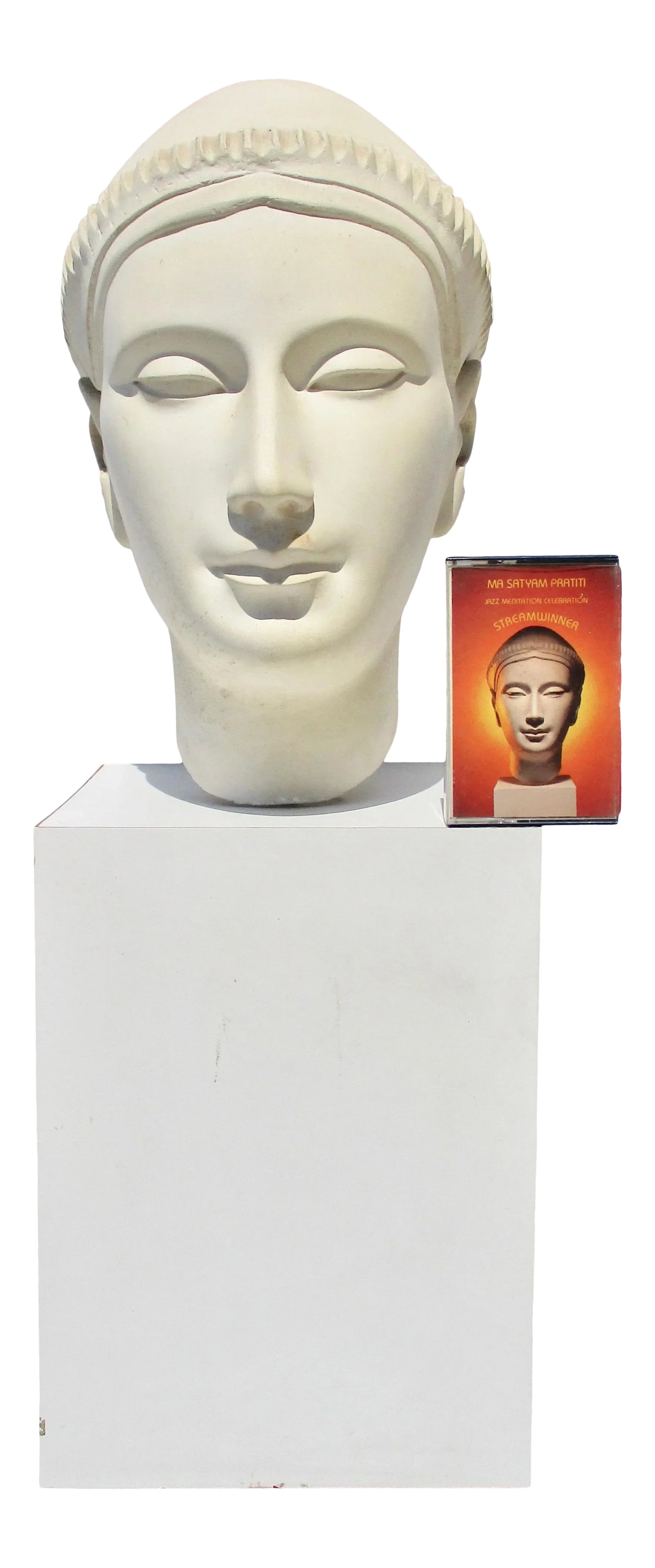 1980s Ageho Album Cover & Head Sculpture - 2 Pieces: Beautiful face in Iconic Asian style. Studio work of male head in knit cap. Presented in meditative pose . This includes a copy of cassette featuring this sculpture. ( Playability unknown/untested).