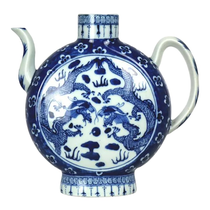 Large 18th Century Chinese Porcelain Teapot With Qianlong Mark on the Bottom: This elegant, large Chinese porcelain teapot features a classic white and blue design, with two intricately detailed dragons facing each other in a striking motif. The teapot's shape is unique, with