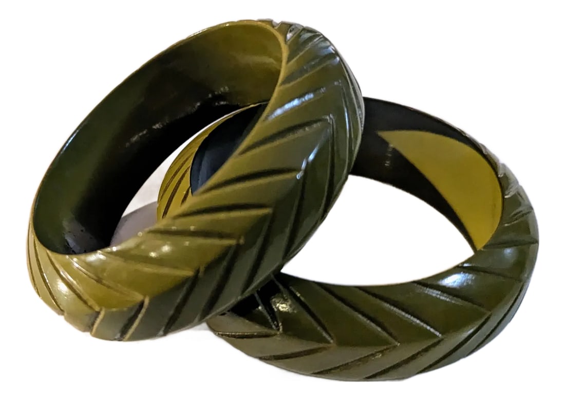 Pair Vintage Olive Green Acrylic Bangles Incised Linear Pattern: 80's pair of acrylic bangles incised linear pattern that together has a leaf-like design. The color is a vibrant olive green. Linear lines on three facets, looking closely stacked zig zags.