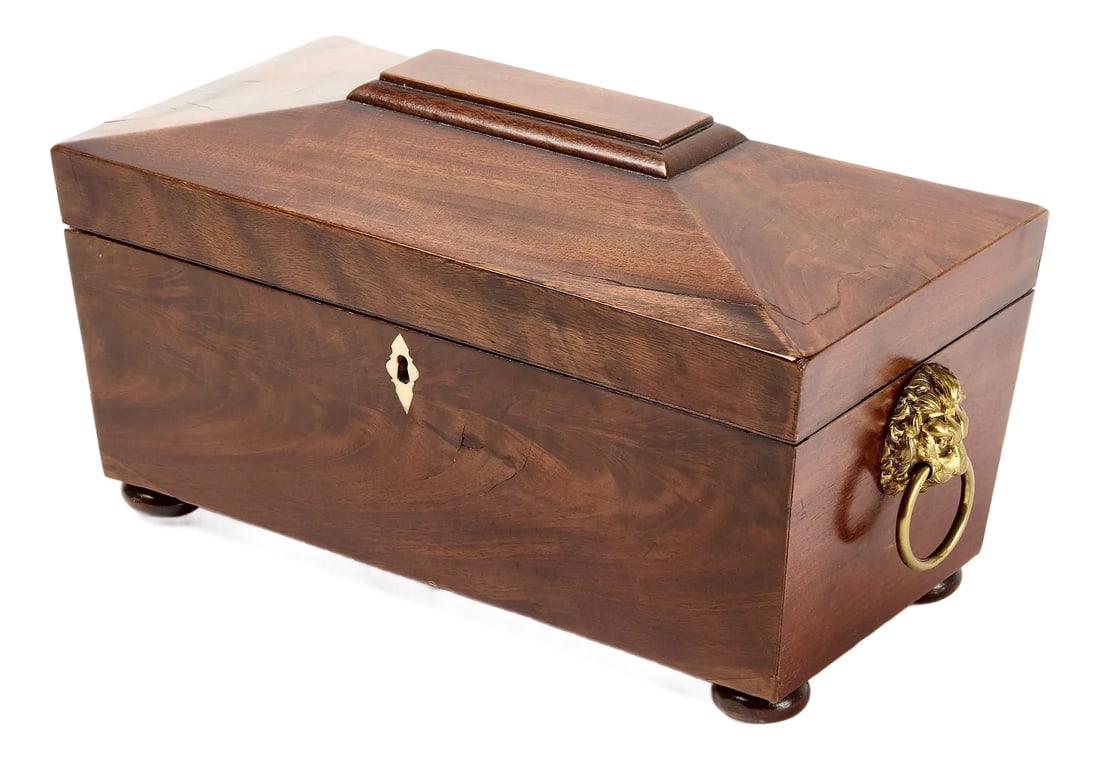 English Regency Sarcophagus-Form Tea Caddy: English Regency Mahogany Tea Caddy. Tea Caddy is in the sarcophagus form with hinged lid concealing a three-section interior. Interior has a fitted glass mixing bowl in center, flanked by lidded compa