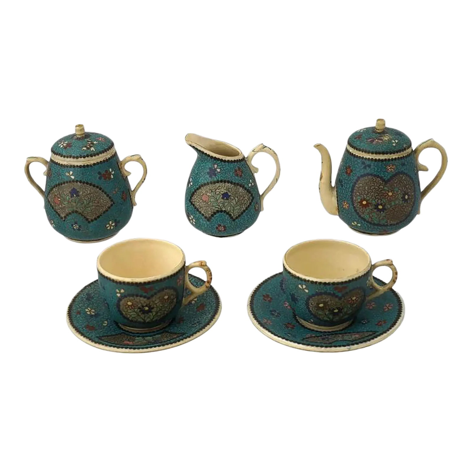 19th Century Japanese Cloisonne Enamel Ceramic Tea Set of 7 Pieces: A Japanese enamel on ceramic tea set. A total of 7 items. The set comprises a pair of cups and saucers, a teapot, a sugar bowl, and a creamer. Each ware is adorned with polychrome enamel figural medal