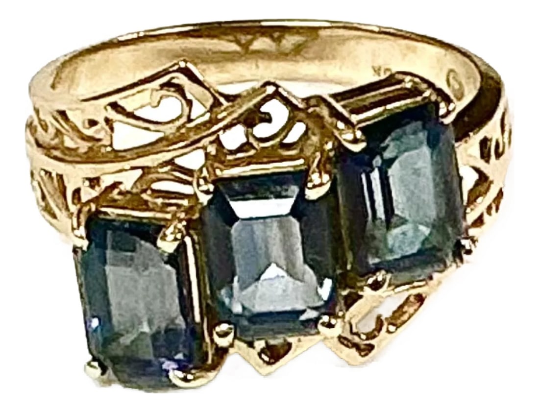 Three Stone Blue Topaz 10k Yellow Gold Ring: 10k yellow gold three stone blue topaz ring, 3.59 Grams TW. The dimensions of the emerald cut stones are approximately 6 x 4.5 mm each. Approximately 0.75 carats each or a total of approximately 2.25