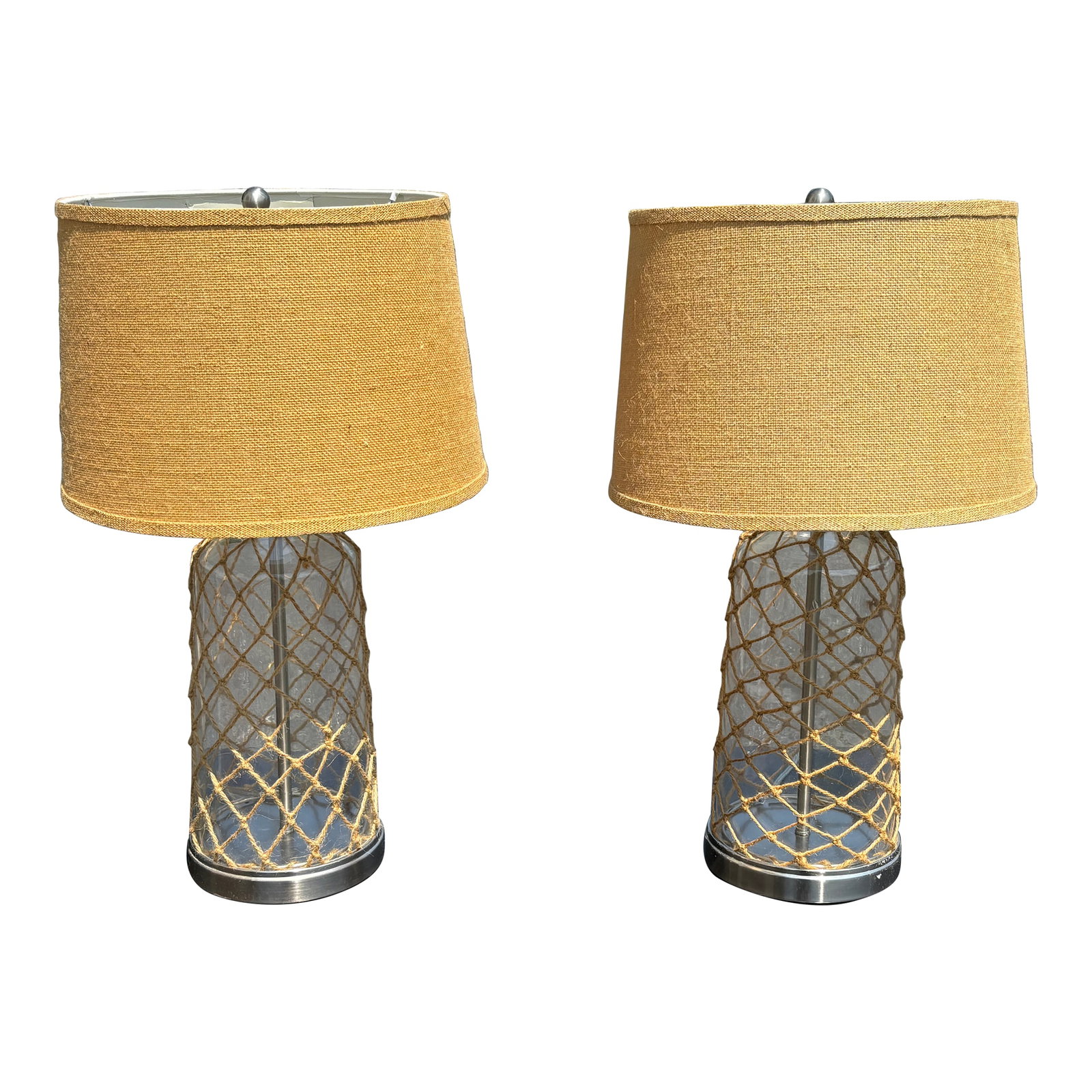 Mid-Century Pair of Nautical Inspired Table Lamps With Linen/Jute Shades and Details: A Nautical Pair! Perfect 1960s/70s era pair of coastal table tamps with original linen / jute / burlap shades and a woven rope theme. . Glass cylinders with layers of rope, above chrome bases and