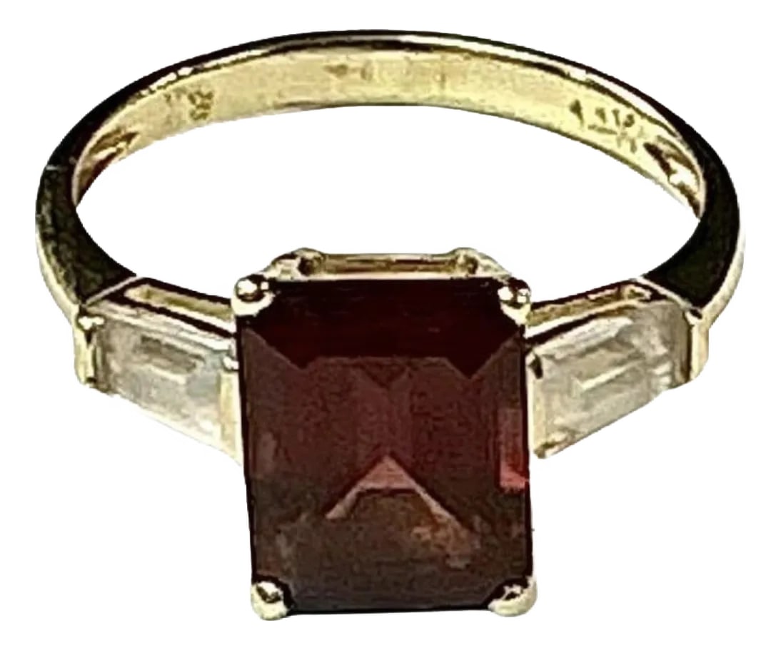 Garnet With Diamond Baguettes 14k Yellow Gold Ring: 14k yellow gold emerald cut Garnet ring, 2.09 Grams TW. The dimensions of the emerald cut garnet is approximately 8.5 mm x 6 mm. Approximately 2 carats. Marked 14K. Approximate size 5.0. Condition: