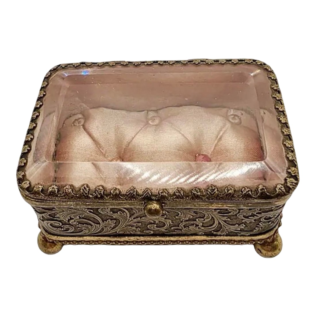 Antique French Ormolu Glass Jewelry Box With Original Tufted Coral Silk Interior: A darling antique French jewelry casket that preserves the elegance of a bygone era. This rectangular trinket box features beveled glass panels and ornate gold-toned ormolu sides, richly adorned with 