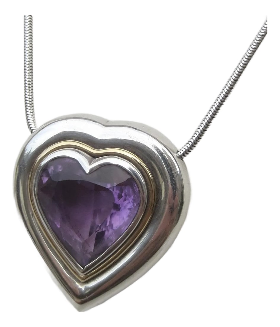 Paloma Picasso for Tiffany Amethyst and Sterling Heart Pendant: Excellent heart-cut amethyst stone in a sterling and 18 kt gold setting. Deep strong purple stone. A snake chain with a safety catch measuring 17" long. The weight is 21 Dwt. Signed and dated by