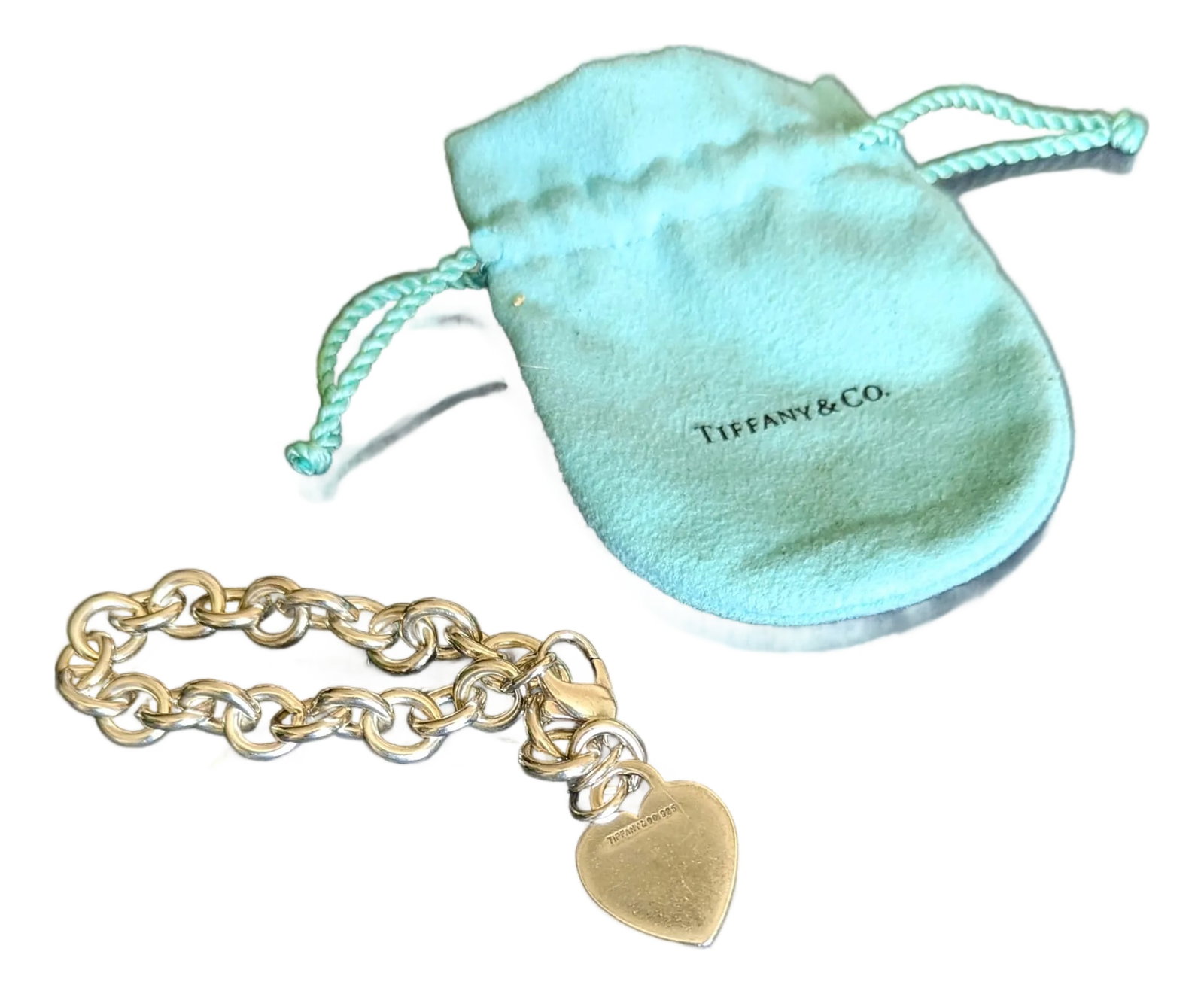 80's Tiffany's Engraved Heart Bracelet Engraved "Nomi", Dust Bag Included: Tiffany & Company charm bracelet from late 80's. Comes with it's original Dustbag. The engraving is of superb quality from Tiffany & Company. Condition: Alterations: Original Condition Unaltered