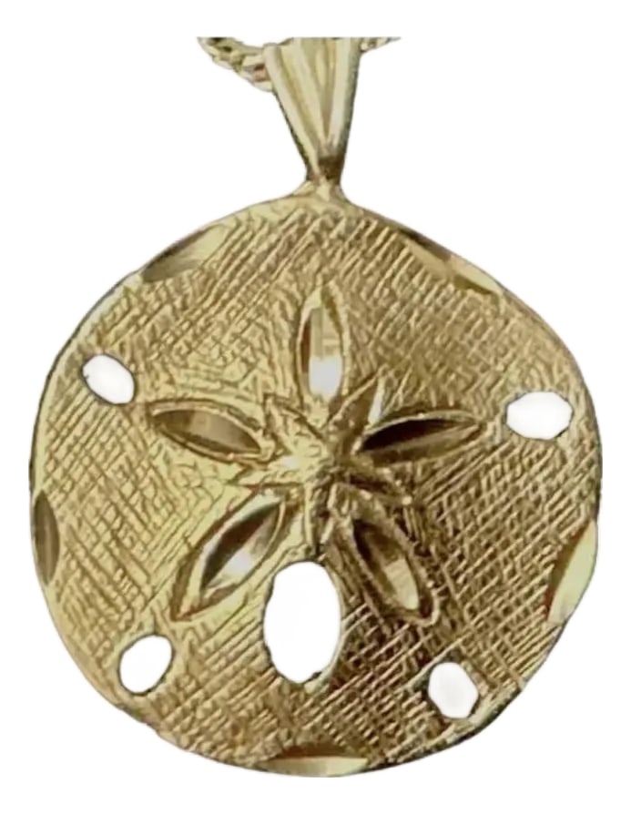 14k Gold Sand Dollar Pendant: 14K Gold Sand Dollar Pendant. Pendant features finely detailed textured surface and cutout accents that capture the natural beauty of the seashell form. Pendant measures 0.75" (19.05mm) in diameter