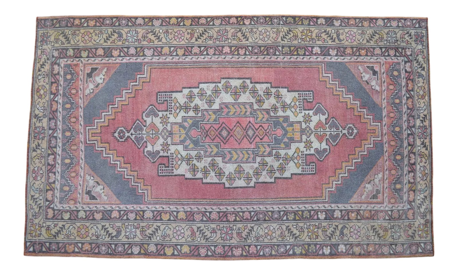 Distressed Area Rug Hand Knotted Colorful Low Pile Oushak Rug - 4' X 6'7'': This is a beautiful vintage hand knotted distressed finish Rug from Turkey. It has faded primary colors on a desaturated pink field . This rug would be an easy to work with in just about any setting.