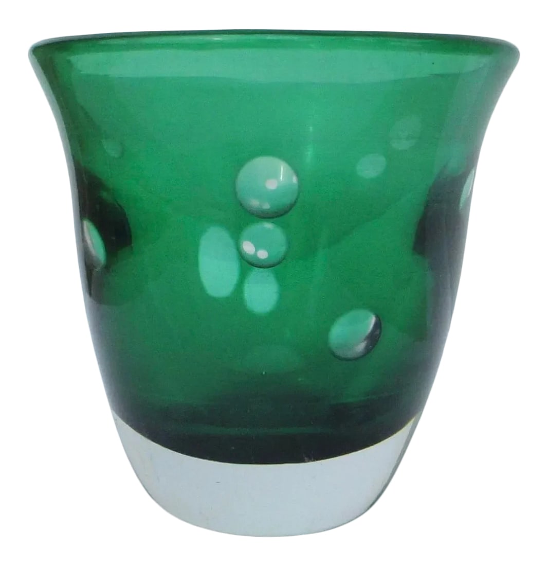 Kosta Boda Vintage Green and Clear Signed Vase: Kosta Boda deep green vase with heavy clear base and wall layer. Carved in circular disks in the wall to reveal a clear body and green inner layer. Signed to the bottom Kosta Boda. The size is 4.4"