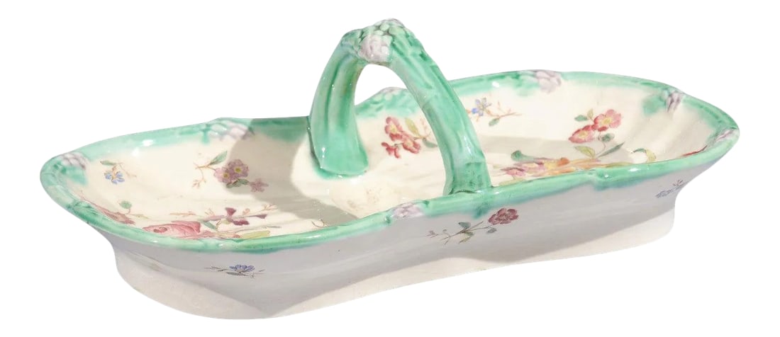 French 19th Century Longchamp Majolica Asparagus Server with Floral Decor: A French Longchamp Majolica asparagus server from the 19th century, with floral decor and C-scroll handle. Born in France during the 19th century, this lovely Majolica asparagus server features a curv
