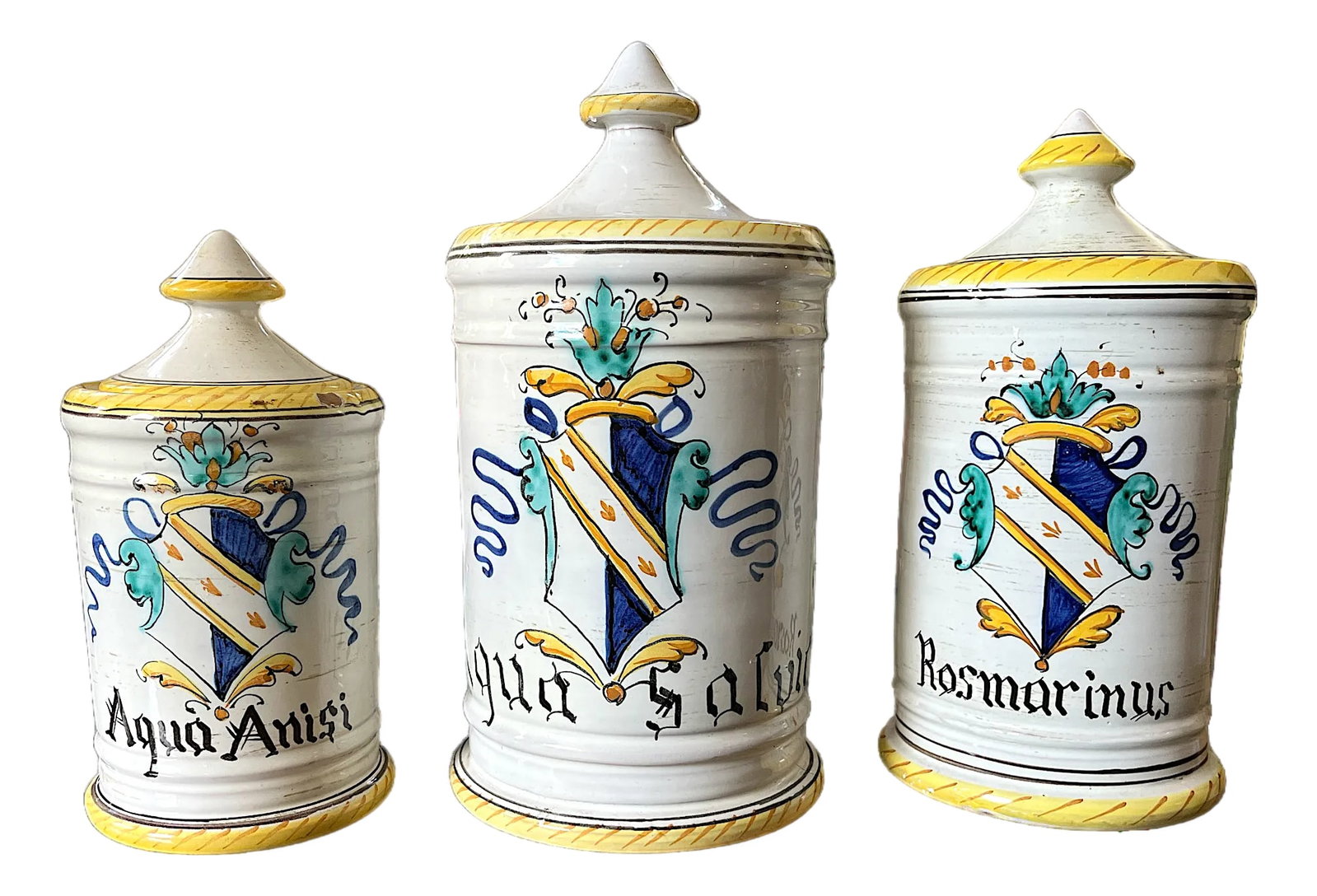 1960s Set of 3 Italian Majolica Apothecary Jars – Aqua Anisi, Rosmarinus & Aqua Salvia: A charming set of three vintage Italian majolica apothecary jars, hand-painted in classic Old World style and labeled Aqua Anisi, Rosmarinus, and Aqua Salvia. Each jar features a traditional