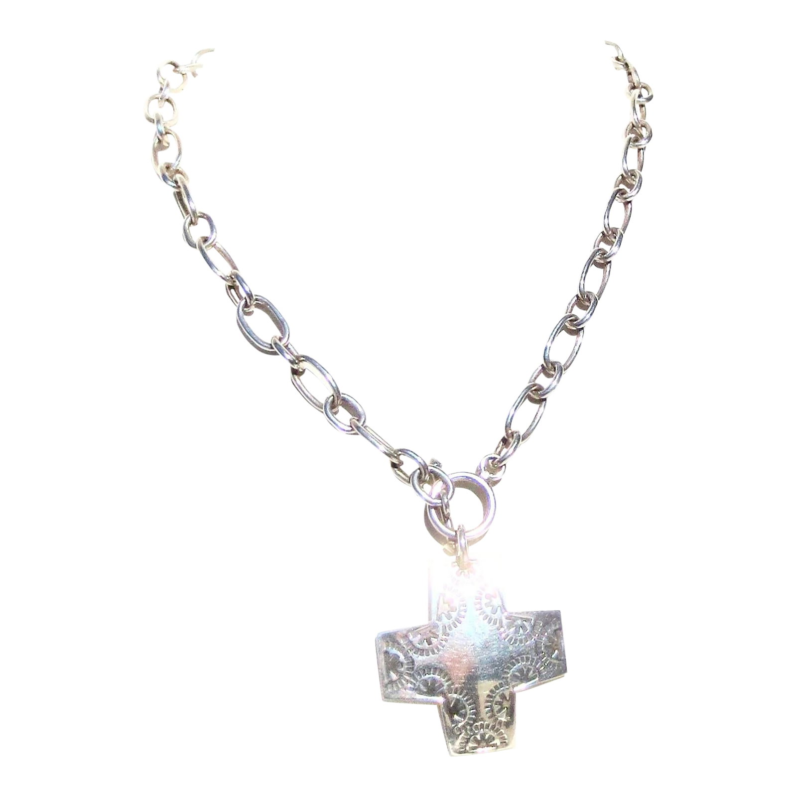 Sterling Silver Chain With Navajo Cross Pendant 25 DWT: Late 20th-century sterling silver link chain necklace. A Navajo cross is attached to a bar and toggle catch measuring 17" long. Navajo cross with hammered design and bowed surface . Marked to the